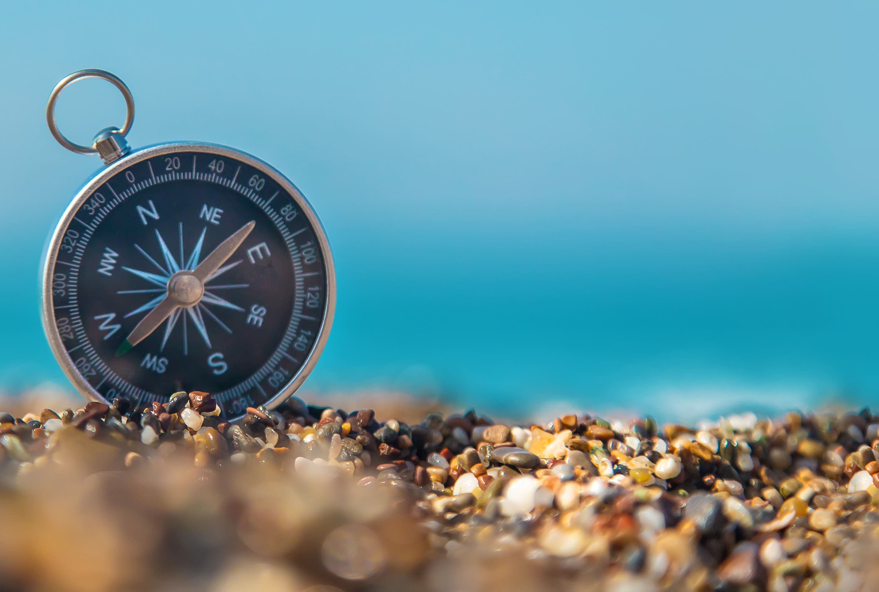 A compass sitting on top of some rocks